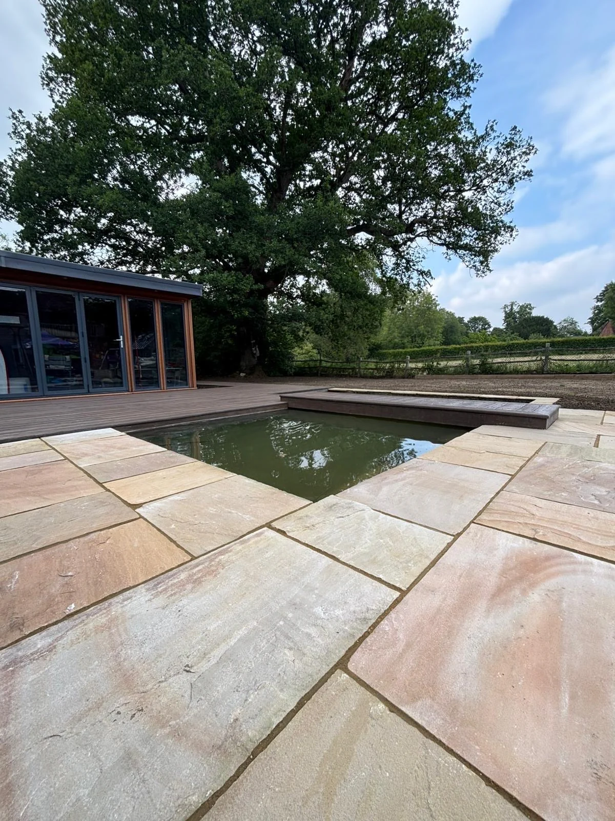 Garden pond within a landscaped planting scheme
